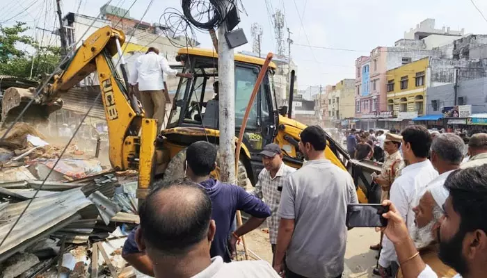 రోడ్డు విస్తరణలో భాగంగా షాపుల తొలగింపు.. స్థానికుల ఆందోళన